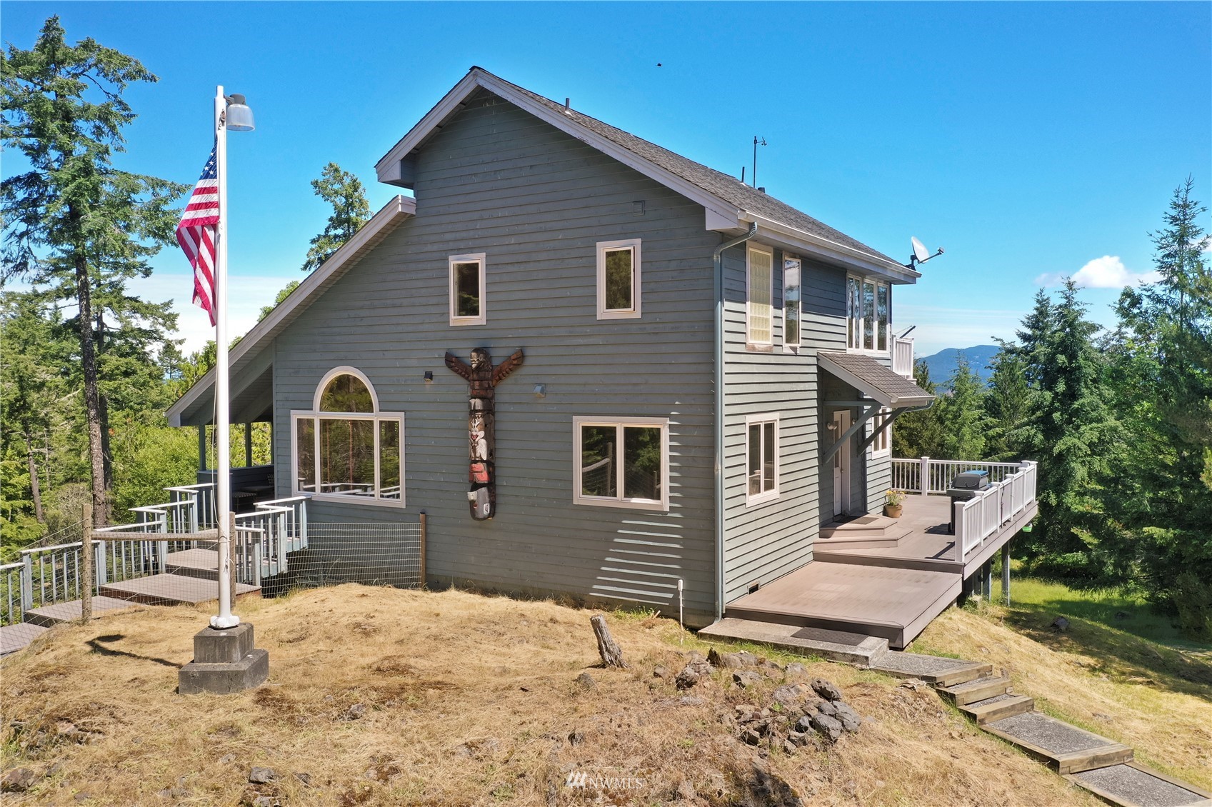 338 Sunrise Ridge Road San Juan Island, WA 98250 - Photo 2 of 39 a backyard of a house with yard and outdoor seating