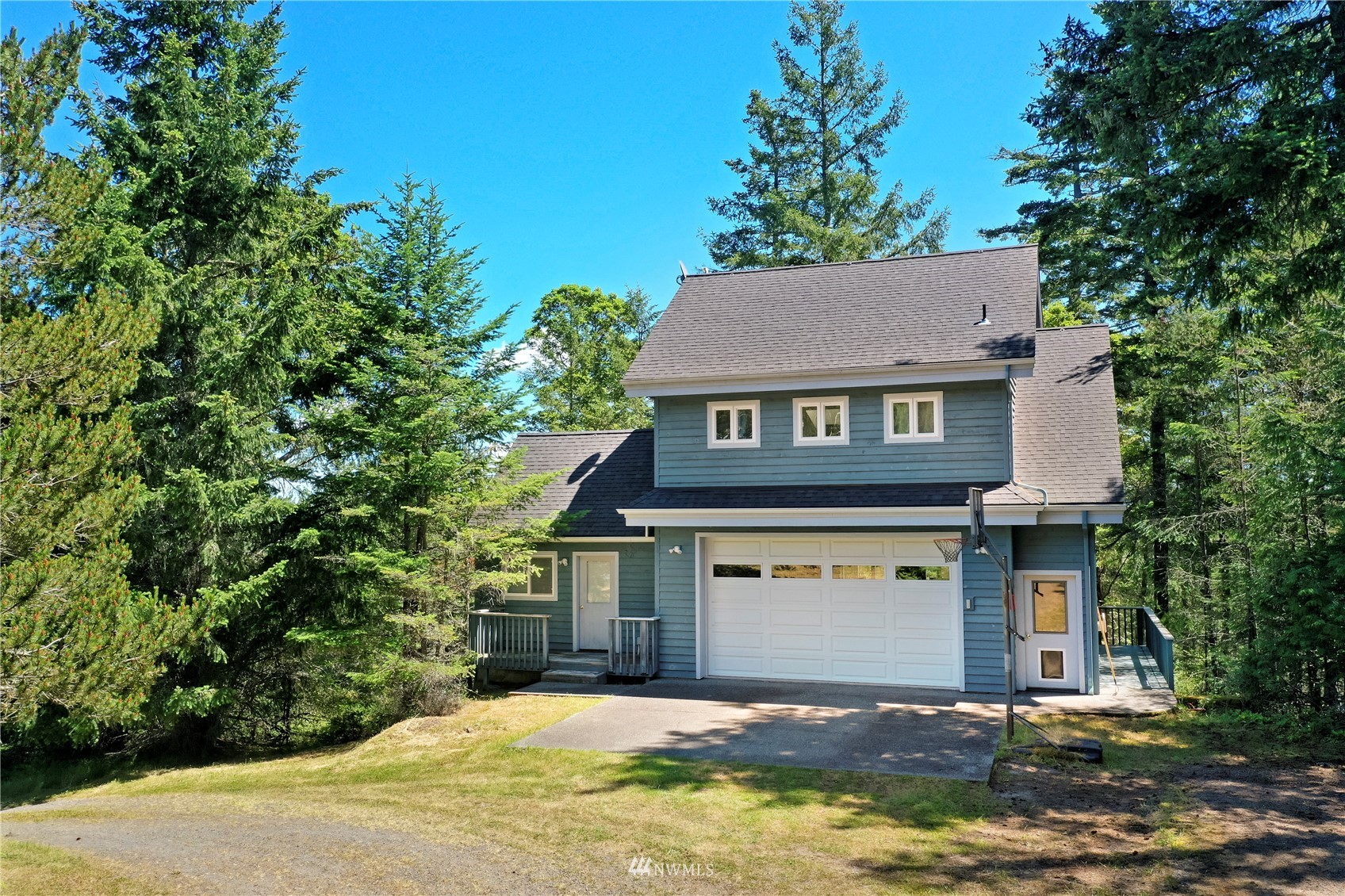 338 Sunrise Ridge Road San Juan Island, WA 98250 - Photo 37 of 39 a front view of a house with a yard and garage
