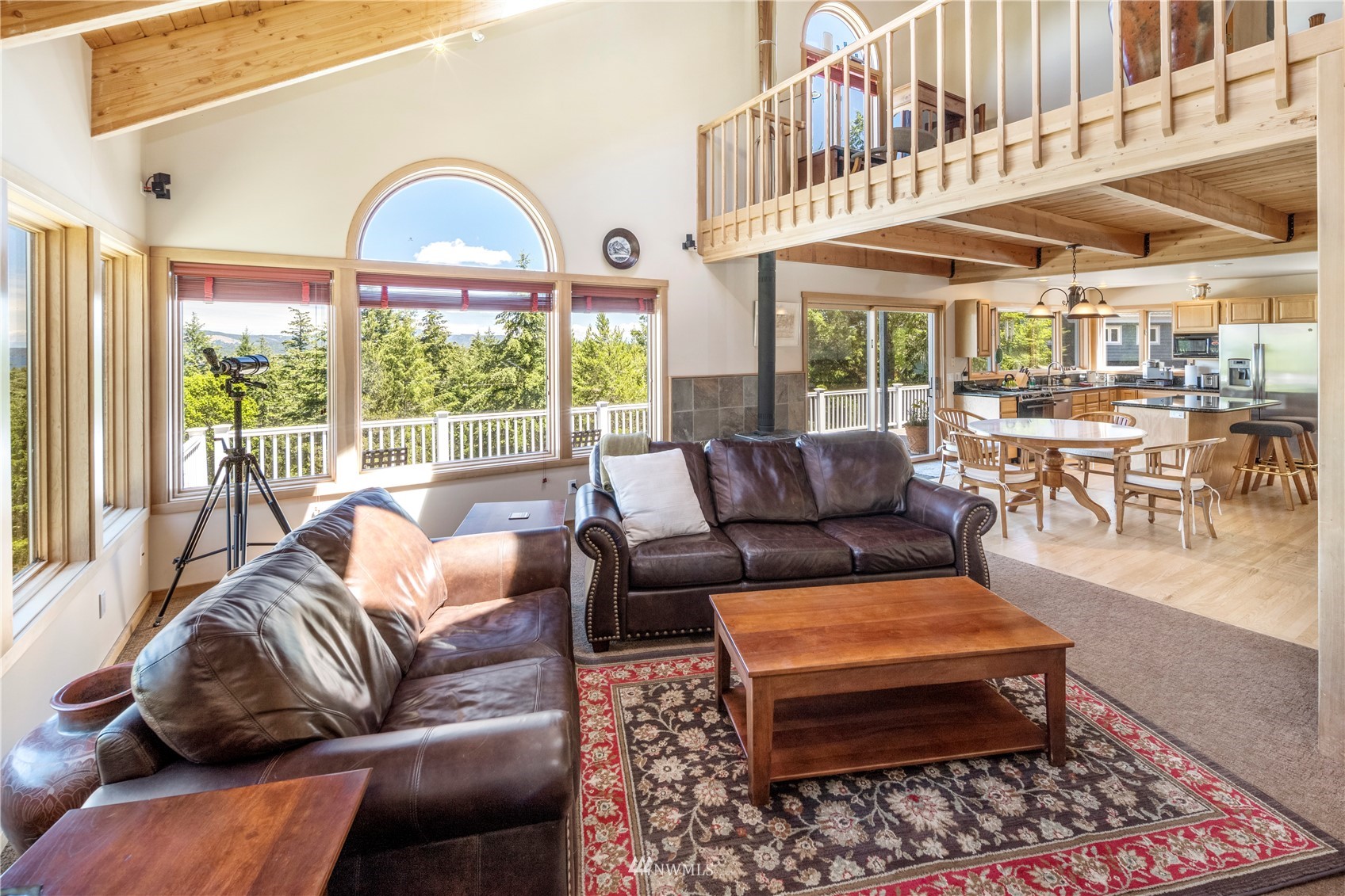 338 Sunrise Ridge Road San Juan Island, WA 98250 - Photo 5 of 39 a living room with furniture a table and a large window