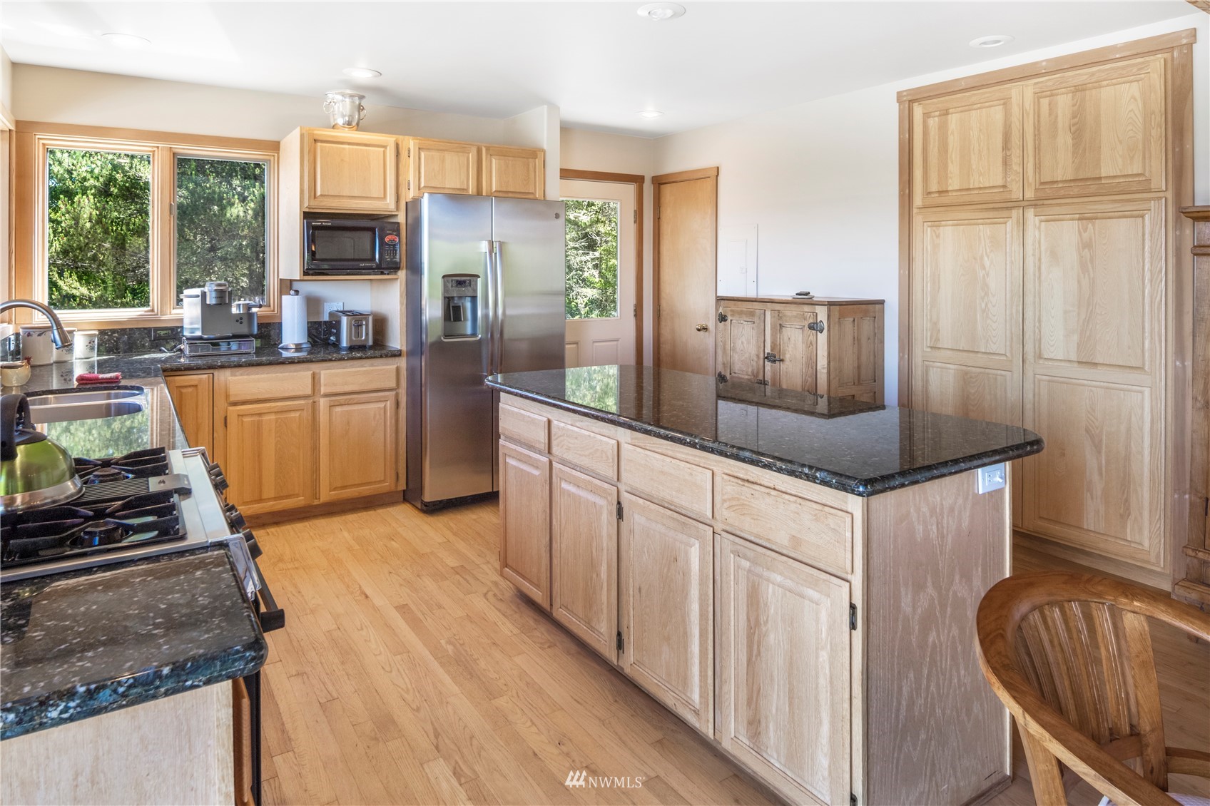 338 Sunrise Ridge Road San Juan Island, WA 98250 - Photo 9 of 39 a kitchen with stainless steel appliances granite countertop a stove a sink and a refrigerator