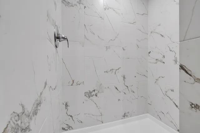 a bathroom with a granite countertop toilet sink and mirror