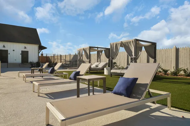 a view of a patio with chairs and tables