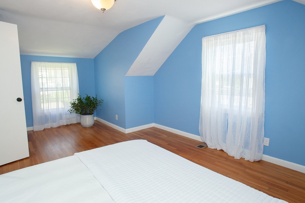 31 East Allen Ridge Road Springfield, MA 01118 - Photo 26 of 34 a bedroom with a bed and wooden floor
