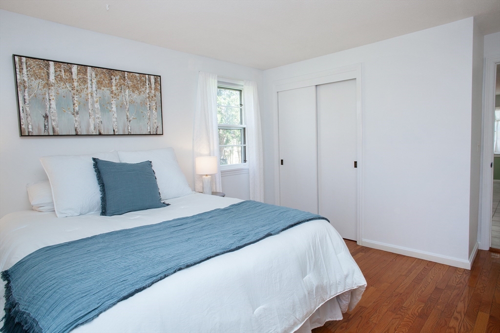 31 East Allen Ridge Road Springfield, MA 01118 - Photo 28 of 34 a bedroom with a large bed and a painting on the wall