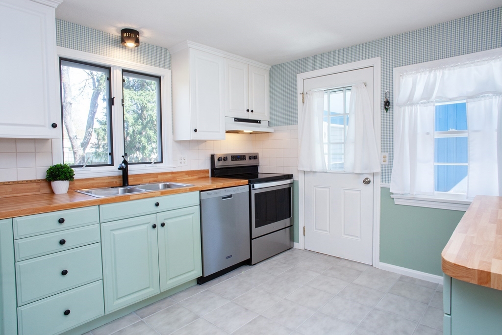 31 East Allen Ridge Road Springfield, MA 01118 - Photo 7 of 34 a kitchen with stainless steel appliances white cabinets and a window