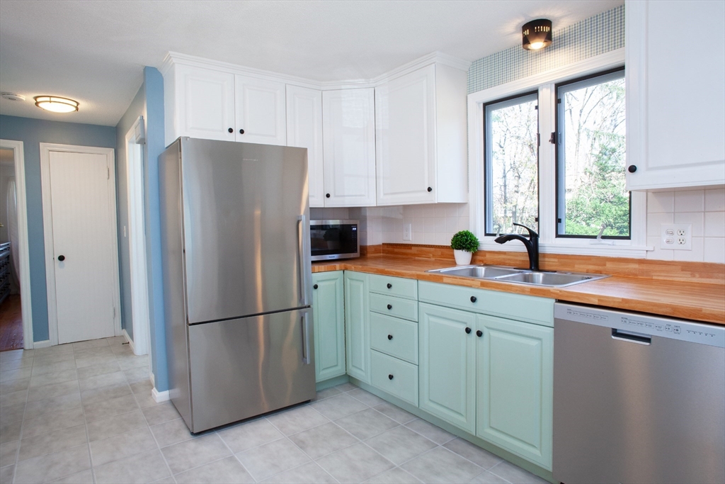 31 East Allen Ridge Road Springfield, MA 01118 - Photo 9 of 34 a kitchen with appliances a window and a refrigerator