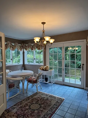 a table and chairs in a room and a window