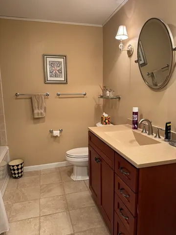 a bathroom with a sink mirror and toilet