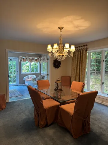 a dining room with furniture and chandelier