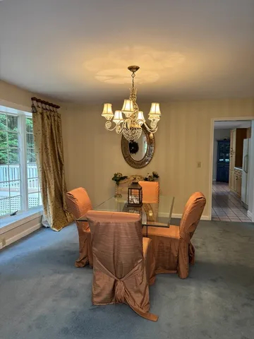 a living room with furniture chandelier and a large window