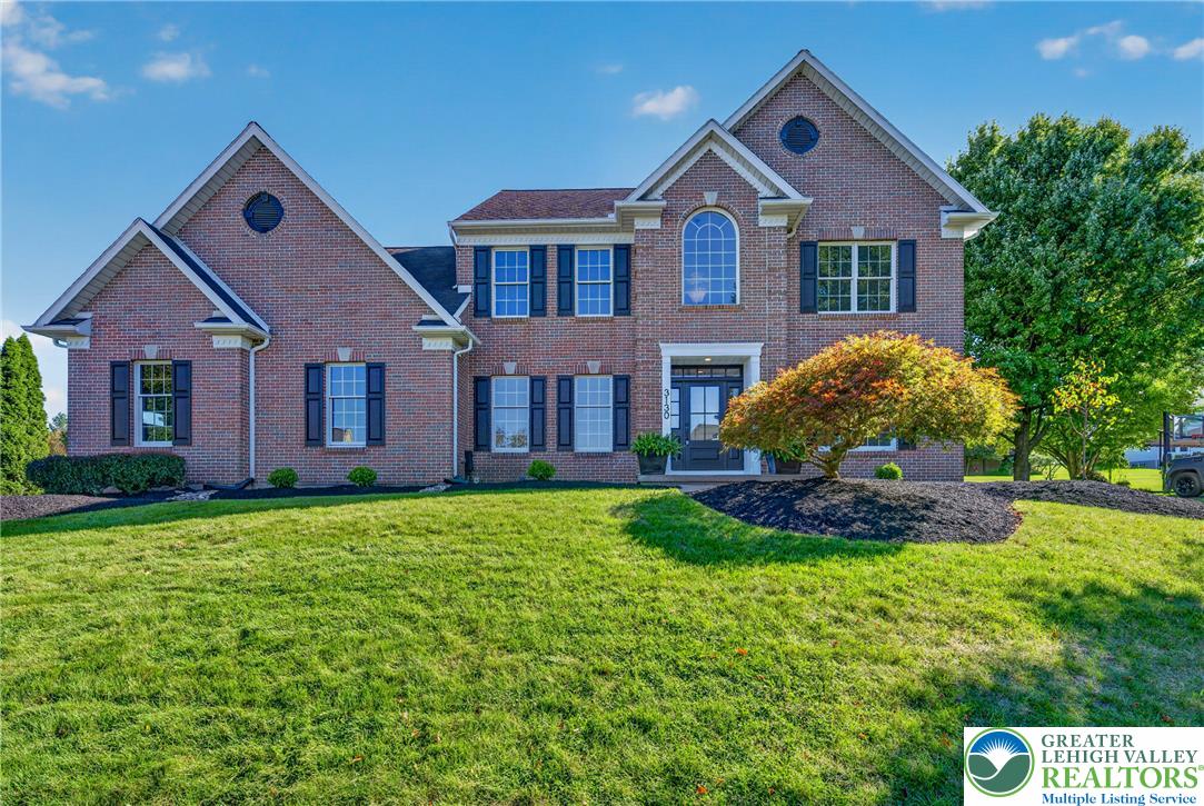 3130 Muirfield Road Center Valley, PA 18034 - Photo 3 of 63 Classic brick craftsmanship defines this grand multi-level exterior set against a lush green lawn.