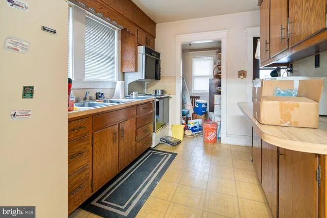 a kitchen with refrigerator and cabinets