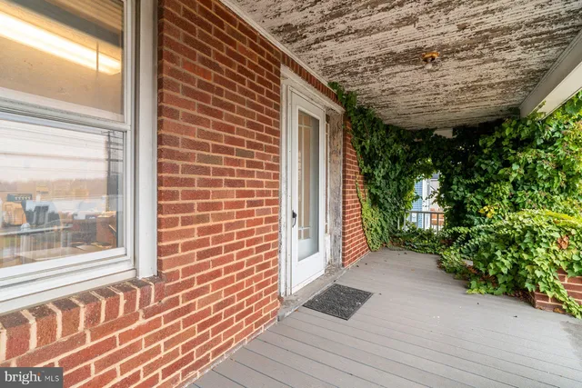 a view of a house with a patio and a yard