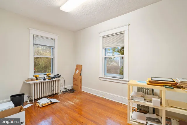 a view of a bedroom with wooden floor