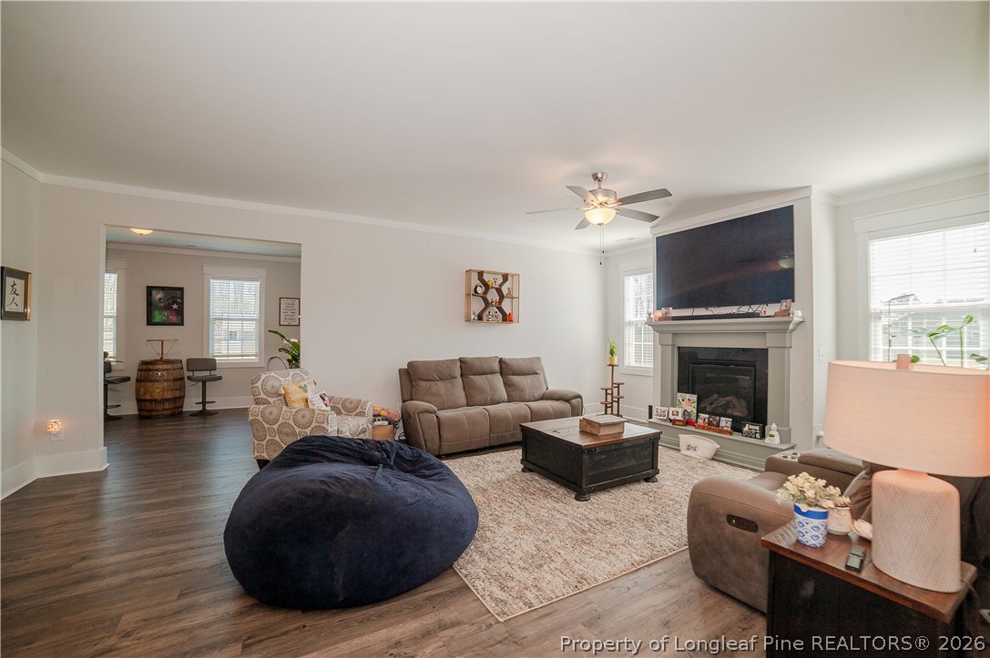 1537 Creekwood Road Hope Mills, NC 28348 - Photo 13 of 41 a living room with furniture a fireplace and a flat screen tv