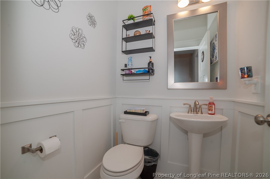 1537 Creekwood Road Hope Mills, NC 28348 - Photo 19 of 41 a bathroom with a toilet sink and mirror