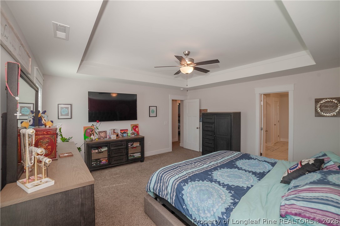 1537 Creekwood Road Hope Mills, NC 28348 - Photo 22 of 41 a bedroom with a bed and a flat screen tv