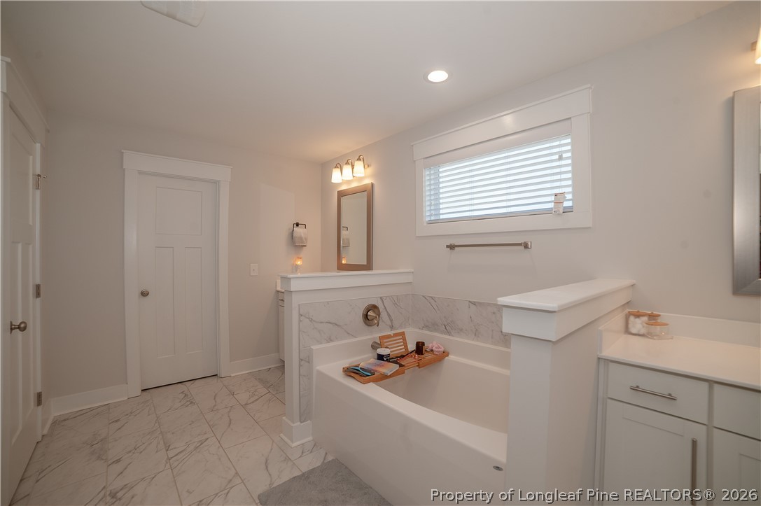 1537 Creekwood Road Hope Mills, NC 28348 - Photo 24 of 41 a bathroom with a sink a bathtub and a window