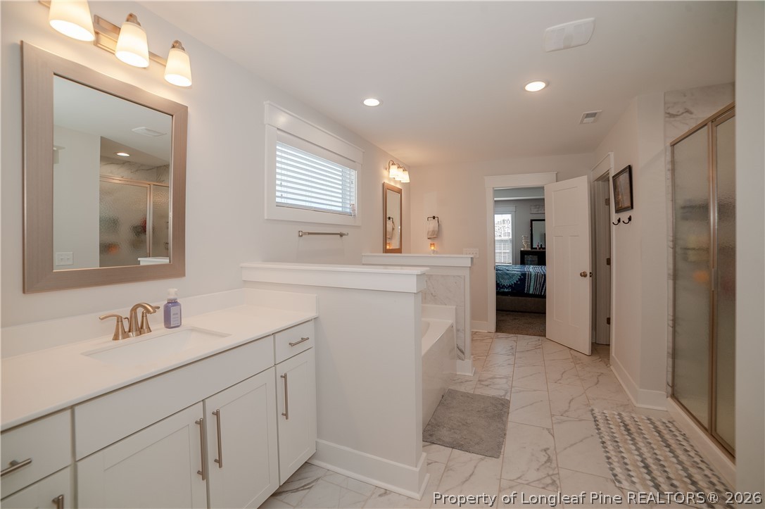 1537 Creekwood Road Hope Mills, NC 28348 - Photo 25 of 41 a bathroom with a sink a mirror and a shower