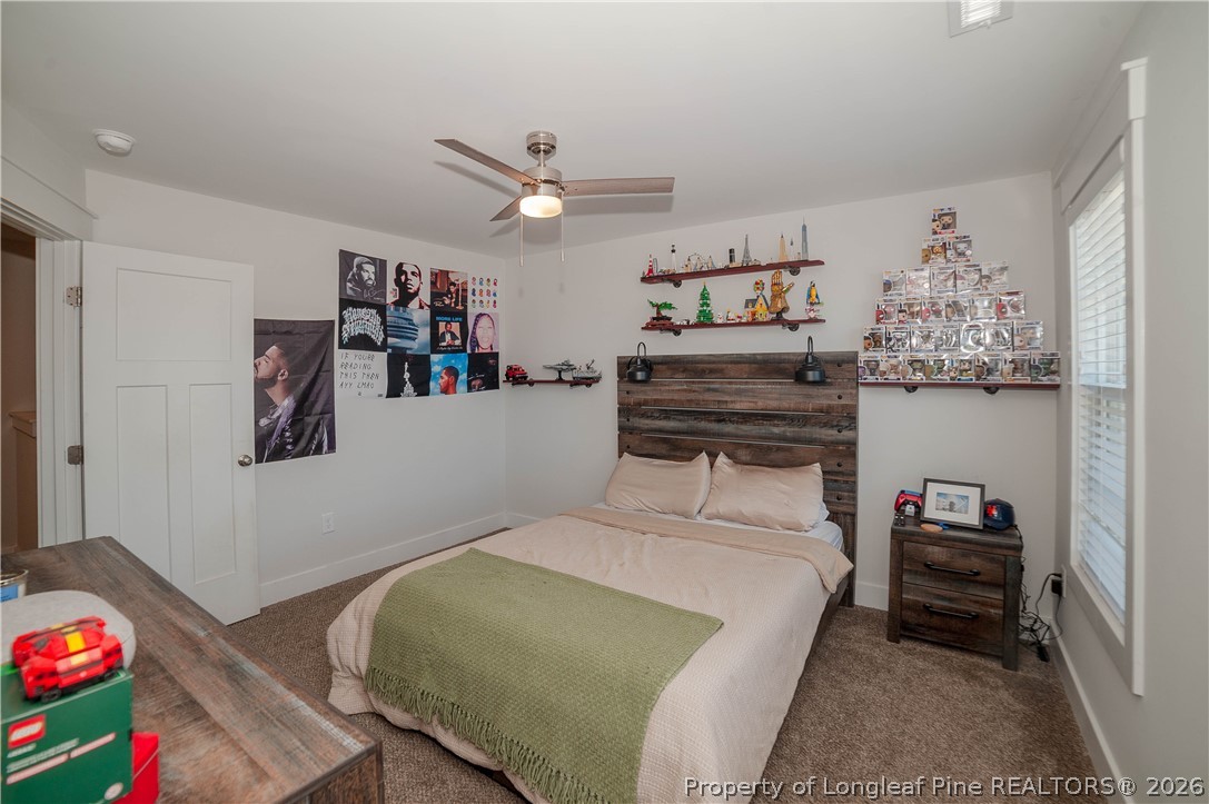 1537 Creekwood Road Hope Mills, NC 28348 - Photo 27 of 41 a bedroom with a bed and cabinets