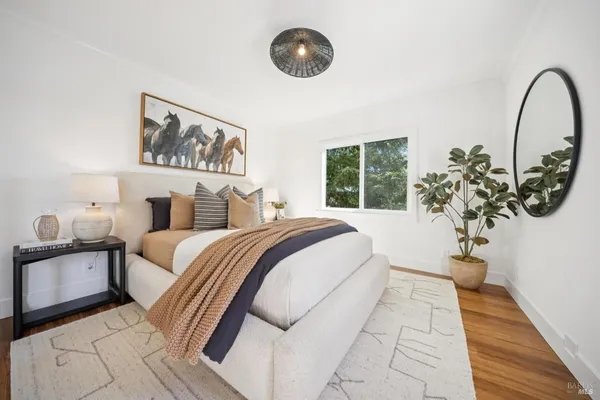 a bedroom with a large bed and a large window