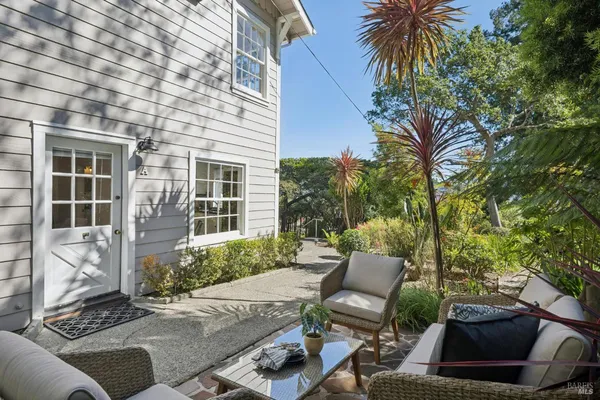a view of a patio with table and chairs and potted plants