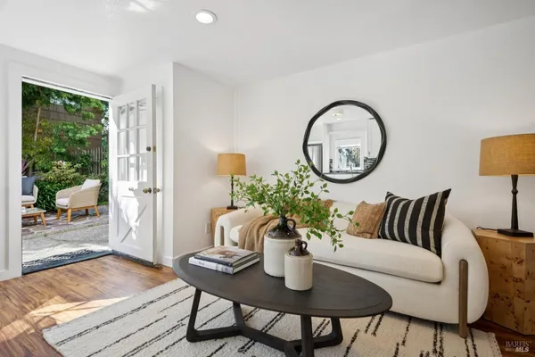 a living room with furniture and a potted plant