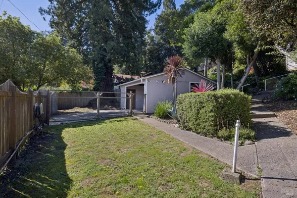 a view of a house with backyard and sitting area
