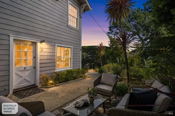 a view of backyard with outdoor seating and plants