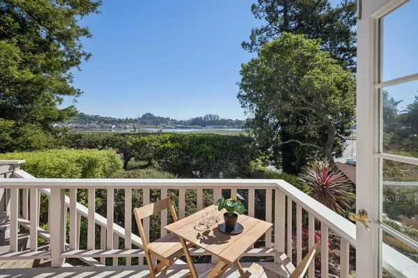 a view of a balcony with wooden floor and fence