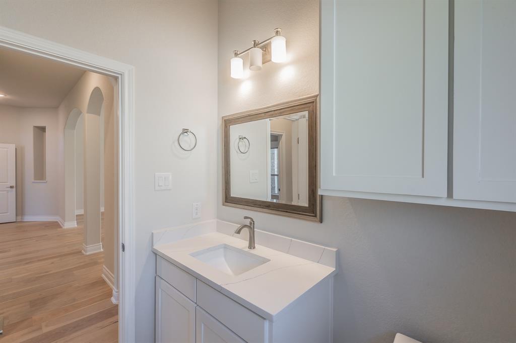 609 Keel Way Azle, TX 76020 - Photo 11 of 32 a bathroom with a sink and a mirror