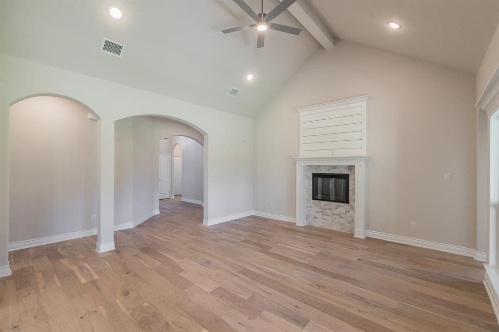 609 Keel Way Azle, TX 76020 - Photo 14 of 32 wooden floor in an empty room with a fireplace