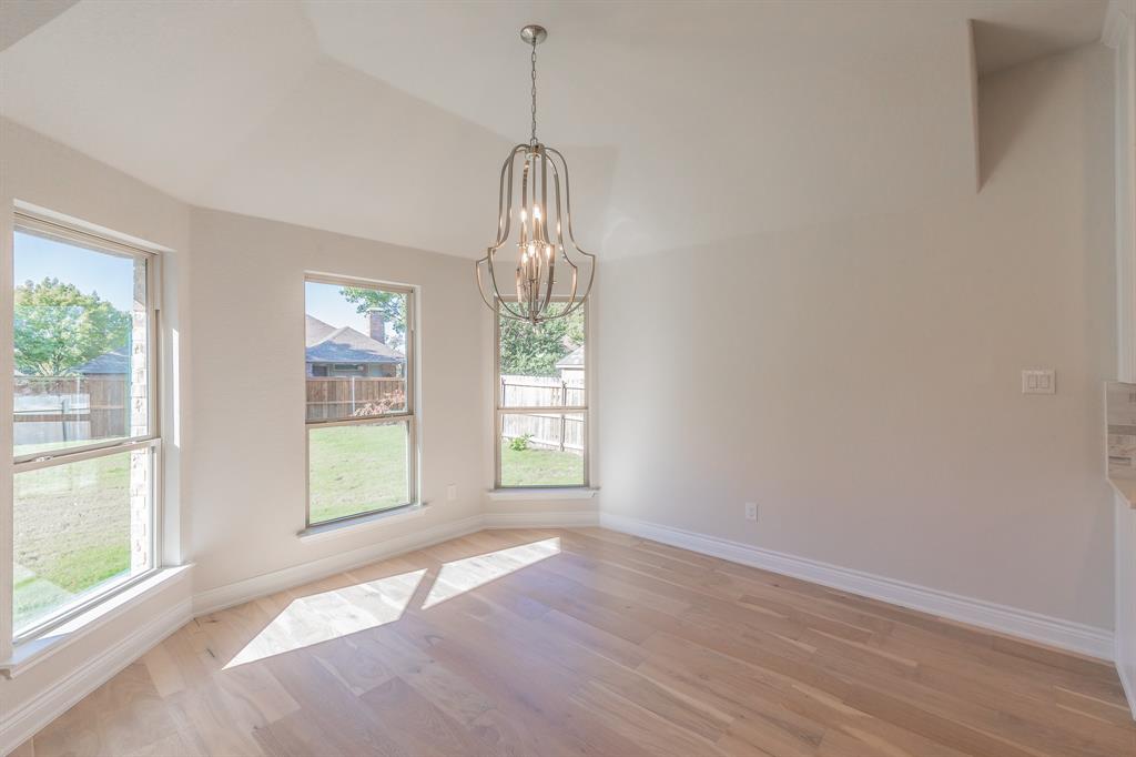 609 Keel Way Azle, TX 76020 - Photo 19 of 32 a view of an empty room with wooden floor and a window