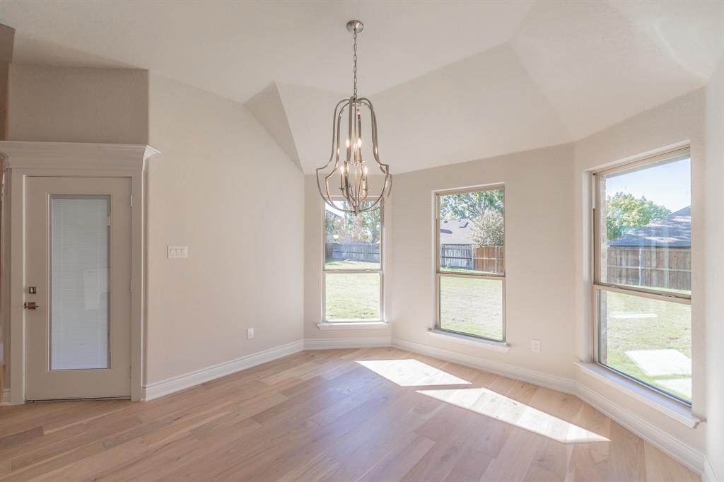 609 Keel Way Azle, TX 76020 - Photo 20 of 32 a view of an empty room with wooden floor and a window