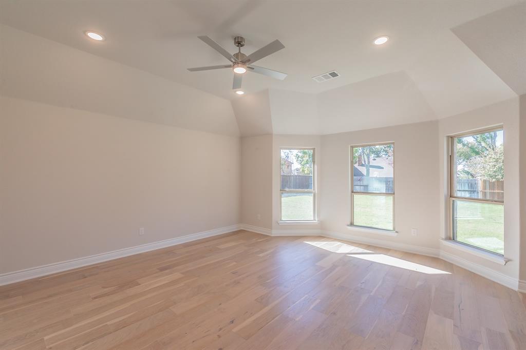 609 Keel Way Azle, TX 76020 - Photo 23 of 32 an empty room with wooden floor and windows