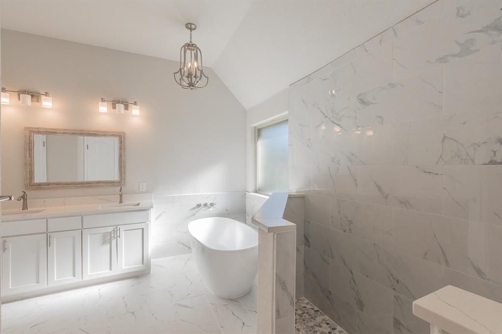 609 Keel Way Azle, TX 76020 - Photo 26 of 32 a spacious bathroom with a toilet sink a mirror and vanity
