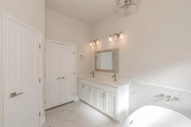a bathroom with a bathtub and a shower
