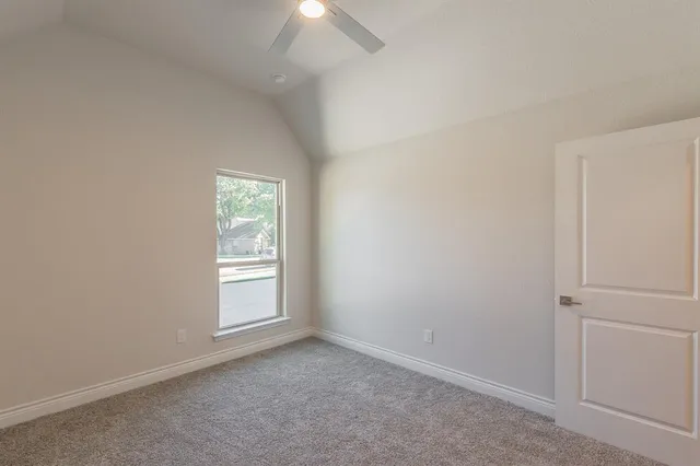 an empty room with a ceiling fan