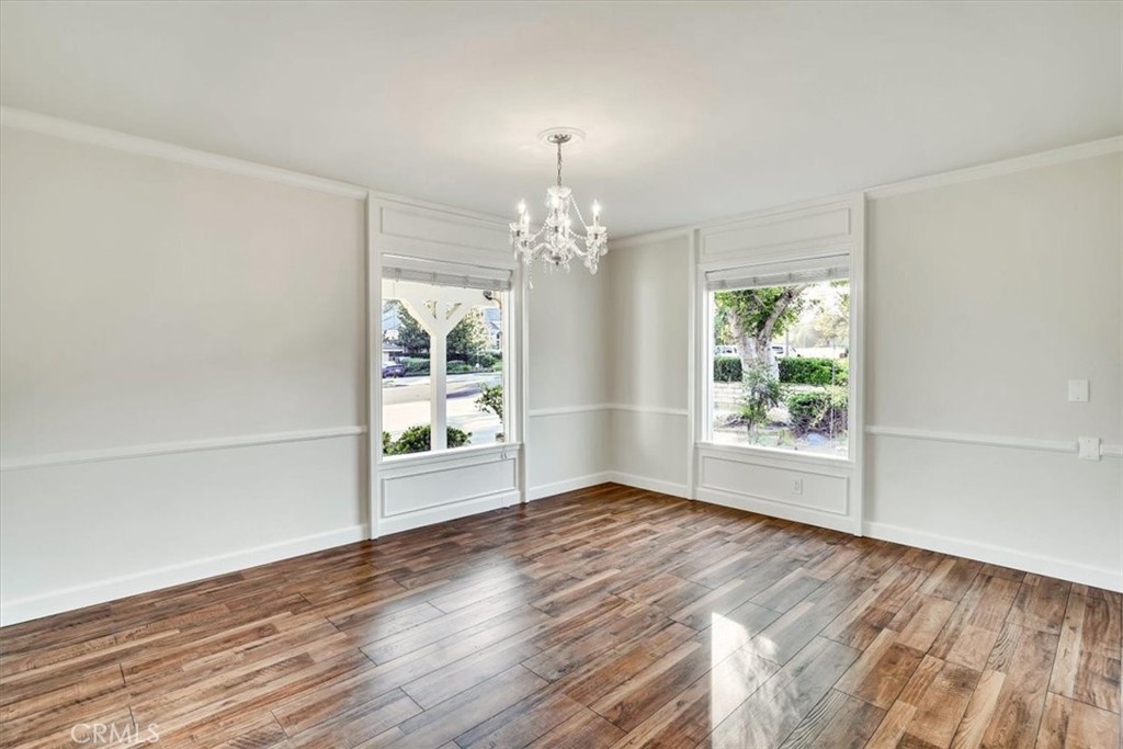 2355 Montecito Drive San Marino, CA 91108 - Photo 11 of 47 an empty room with wooden floor chandelier and windows