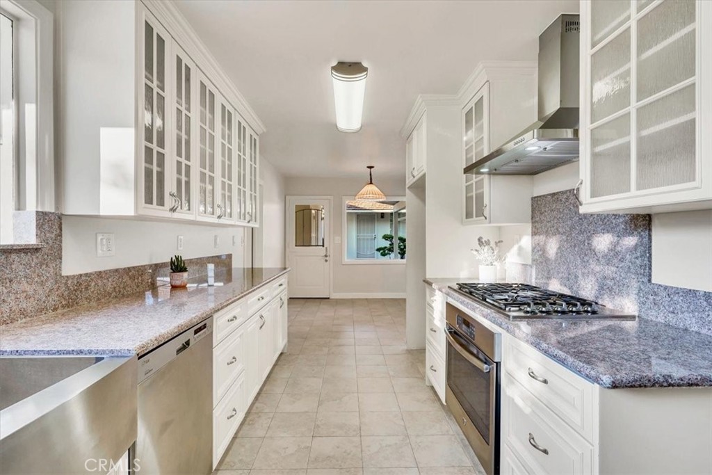 2355 Montecito Drive San Marino, CA 91108 - Photo 13 of 47 a kitchen with stainless steel appliances granite countertop a stove and a sink