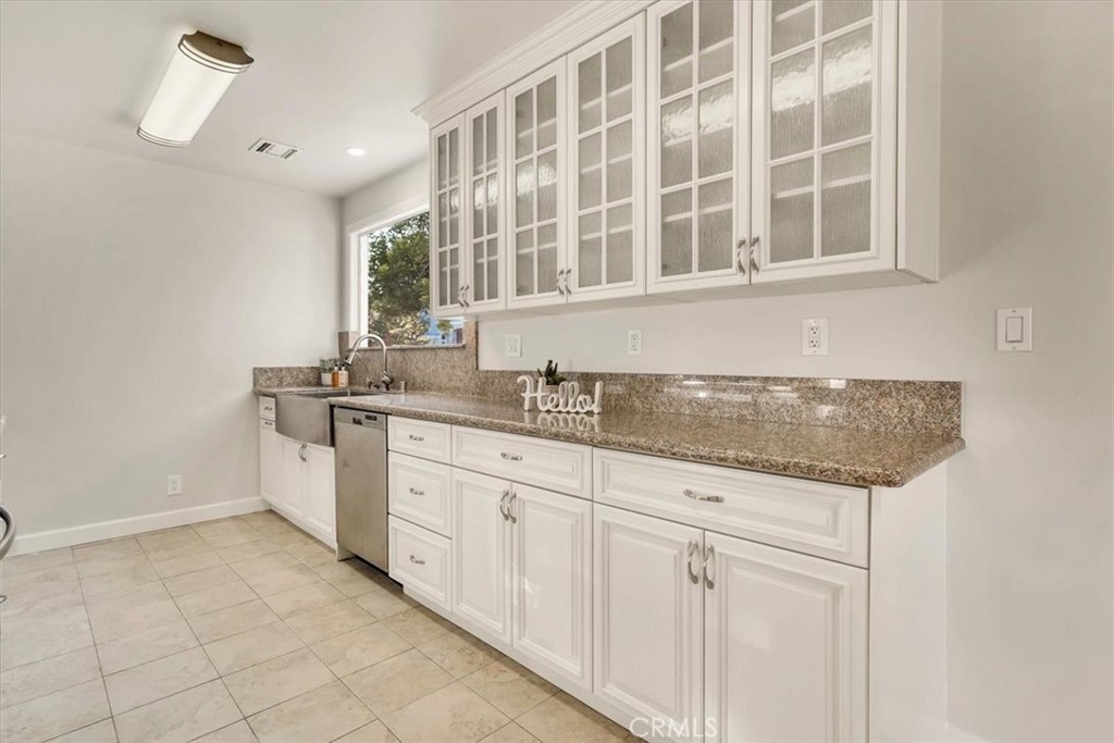 2355 Montecito Drive San Marino, CA 91108 - Photo 14 of 47 a kitchen with granite countertop white cabinets and a sink