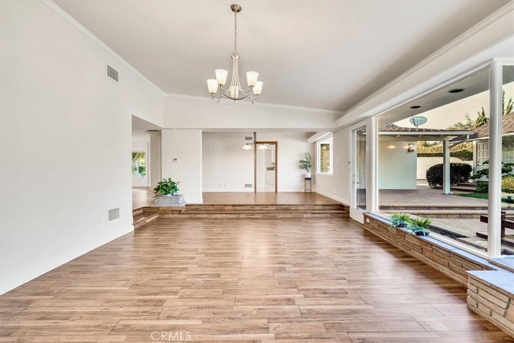 2355 Montecito Drive San Marino, CA 91108 - Photo 18 of 47 a view of an empty room with kitchen and chandelier