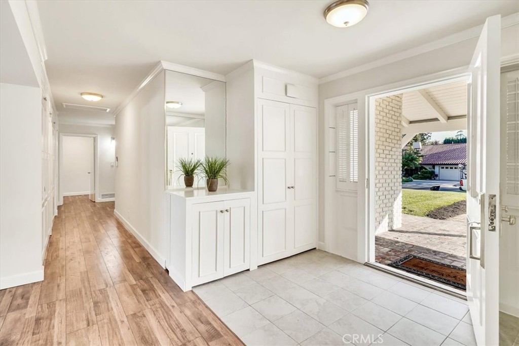 2355 Montecito Drive San Marino, CA 91108 - Photo 5 of 47 a view of a hallway to a livingroom with wooden floor a ceiling fan and windows