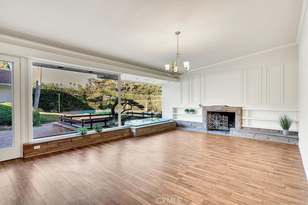 2355 Montecito Drive San Marino, CA 91108 - Photo 6 of 47 a view of empty room with wooden floor and fireplace