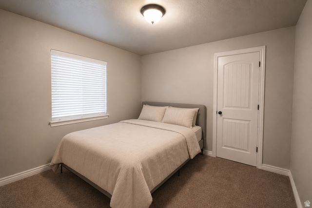 896 Cres Drive South Mapleton, UT 84664 - Photo 27 of 32 Carpeted bedroom featuring neutral wall tones, a window with horizontal blinds, and a white paneled door