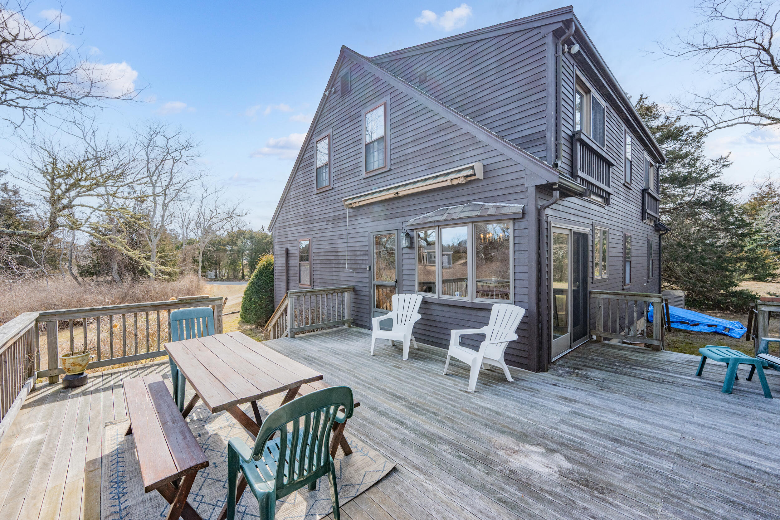 80 Dyer Prince Road Eastham, MA 02642 - Photo 30 of 39 a view of a dinning table and chairs in patio of the house