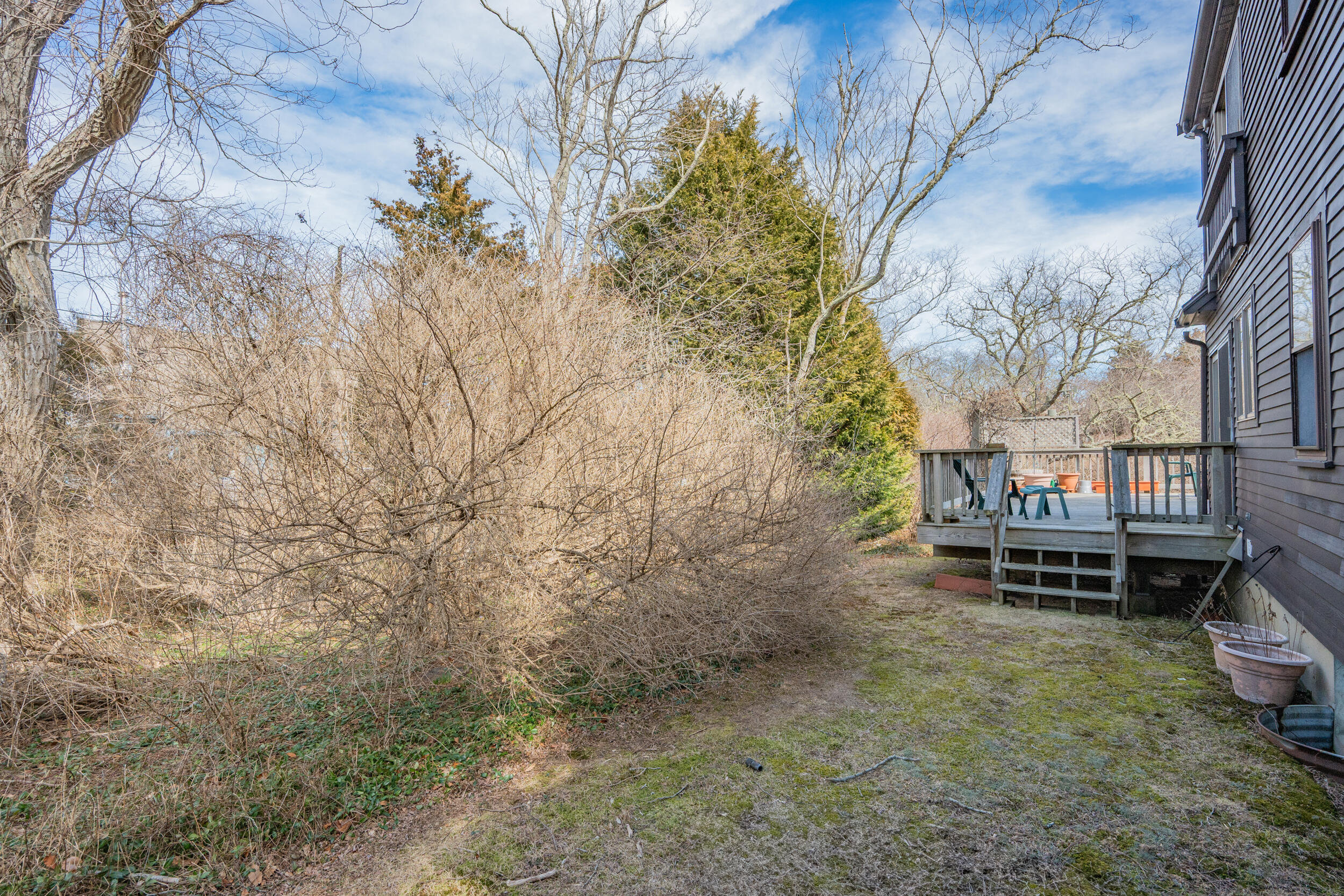 80 Dyer Prince Road Eastham, MA 02642 - Photo 34 of 39 a backyard of a house with wooden fence and trees