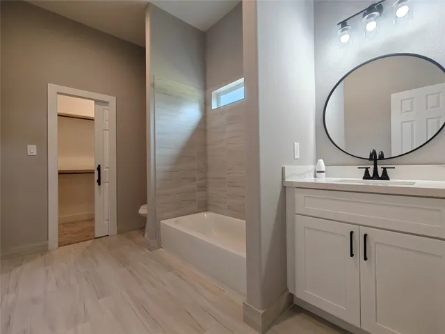 a bathroom with a sink a mirror and a bathtub