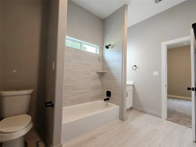 a bathroom with a toilet and a bathtub