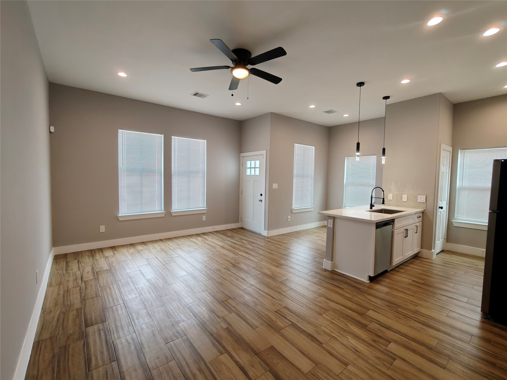 4124 Vaughn Street, Unit B Houston, TX 77016 - Photo 4 of 19 a view of an empty room with a window and wooden floor